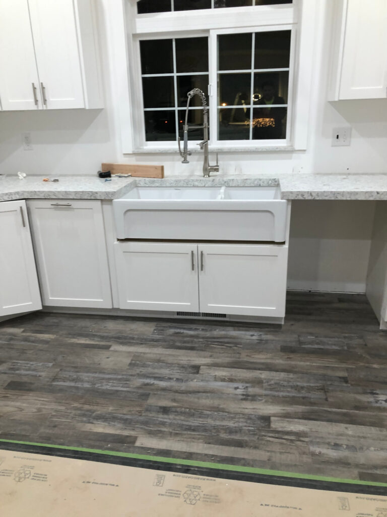 White kitchen cabinets with a farmhouse sink